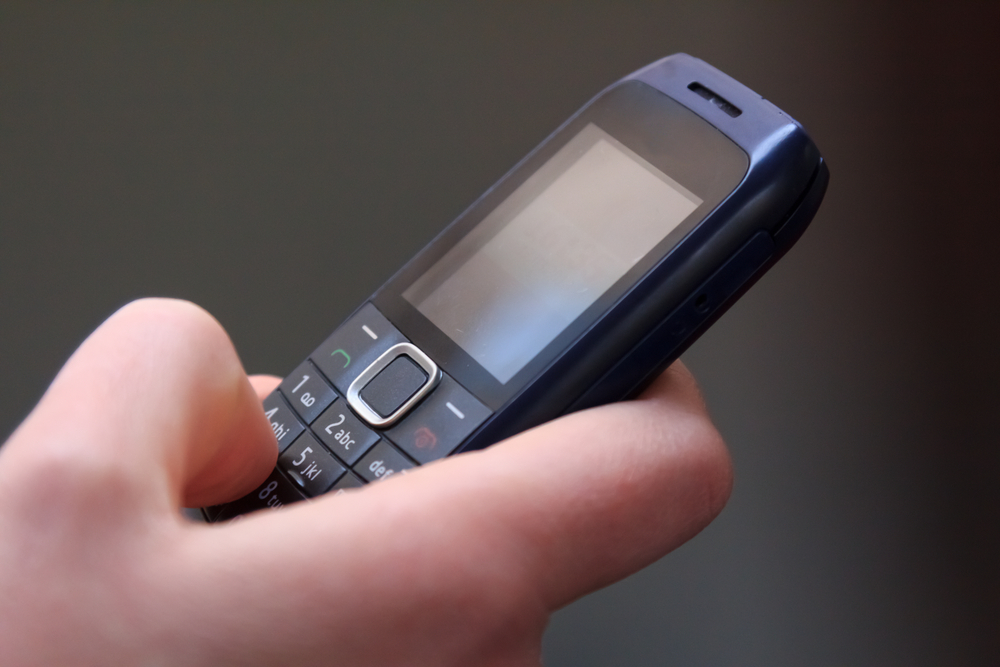 Closeup of texting on an old cell phone