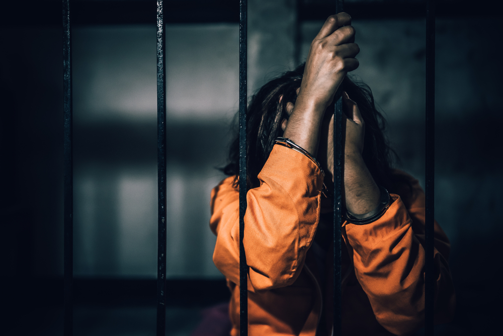Portrait of women desperate to catch the iron prison,prisoner concept,thailand people,Hope to be free,If the violate the law would be arrested and jailed.
