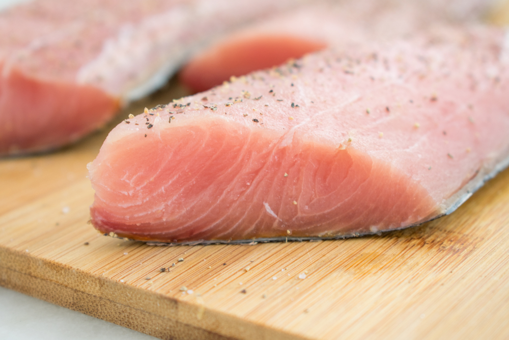 Raw Mahi Mahi (Dolphin Fish) Fillets on a Cutting Board
