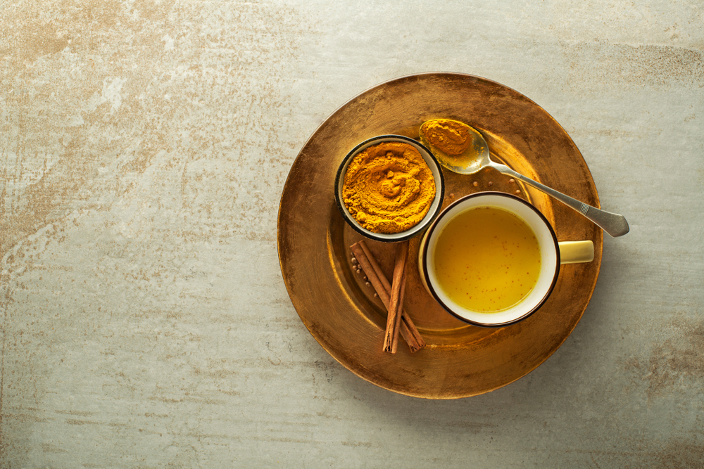 Healthy drink made from turmeric roots, spices, milk and honey. Golden Milk, made with turmeric and other spices
