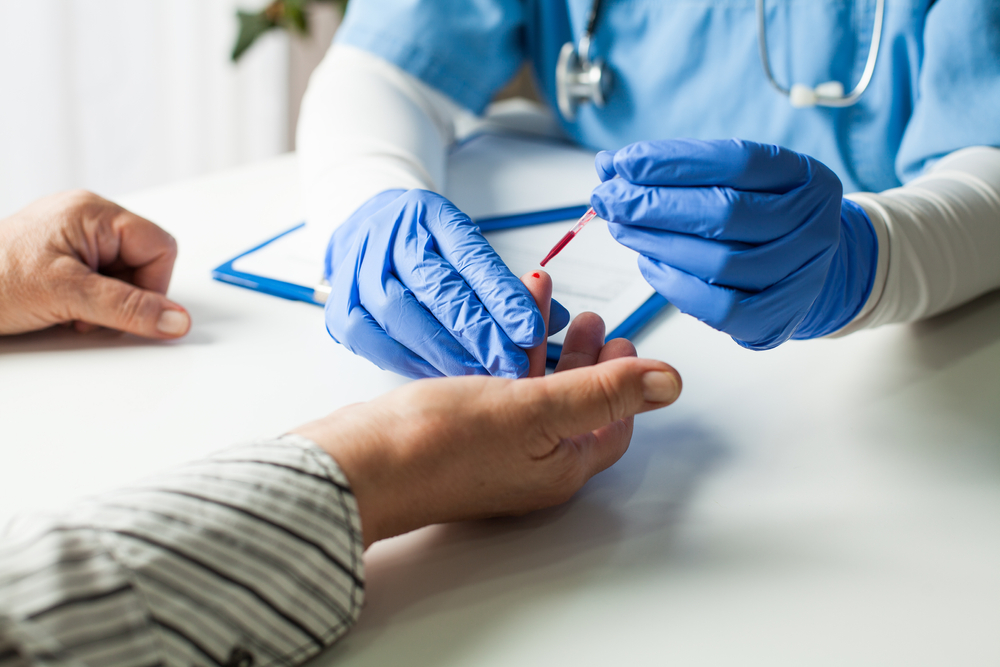 NHS UK doctor taking patient blood sample,serologic finger prick PRP blood antibodies test to determine whether person developed immunity to novel Coronavirus,global COVID-19 pandemic health crisis
