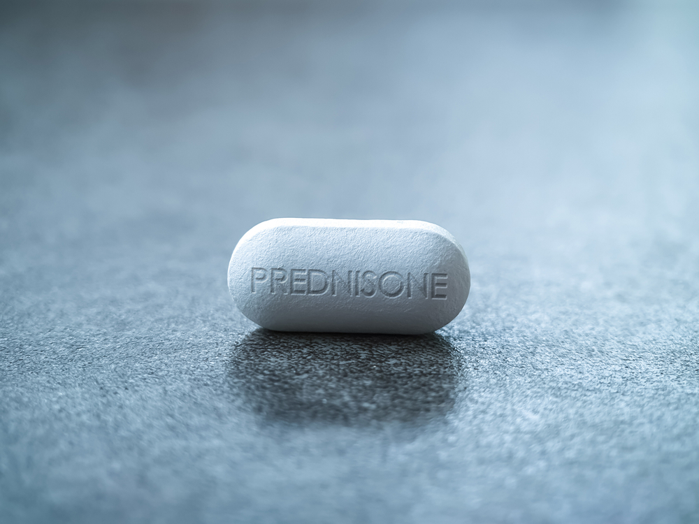 Prednisone tablet drug close up Glucocorticoid medication used to suppress the immune system in asthma, COPD, rheumatologic diseases