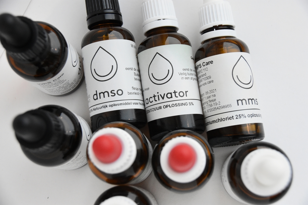 Dobele, Latvia - November 4 2021: DMSO, Activator and MMS in a bottles on a table. Three ingredients to detox the body, alternative medicine. Not approved by official pharma companies.
