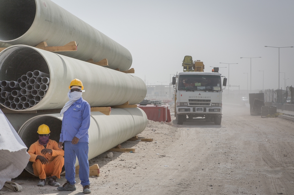 DOHA, QATAR - JULY 27, 2019: Construction workers in Qatar, where foreign workers make up about 95% of the country's total labor force. Qatar is accused of failing to stop abuses of migrant workers.
