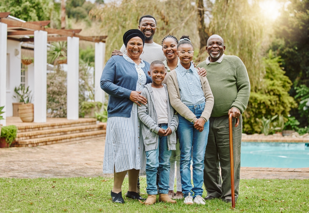 Picture perfect family. Full length portrait of a multi-generational family standing outside in the garden.
