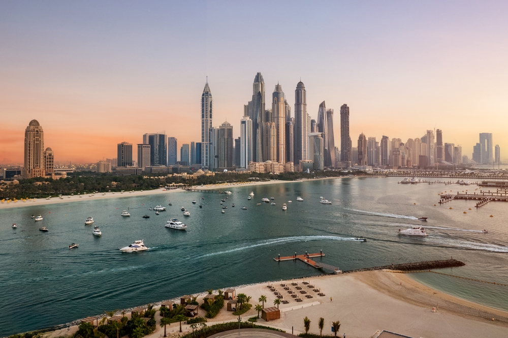 Dubai Marina Skyline and Luxury boats and yachts moving in Sea of Dubai Marina
