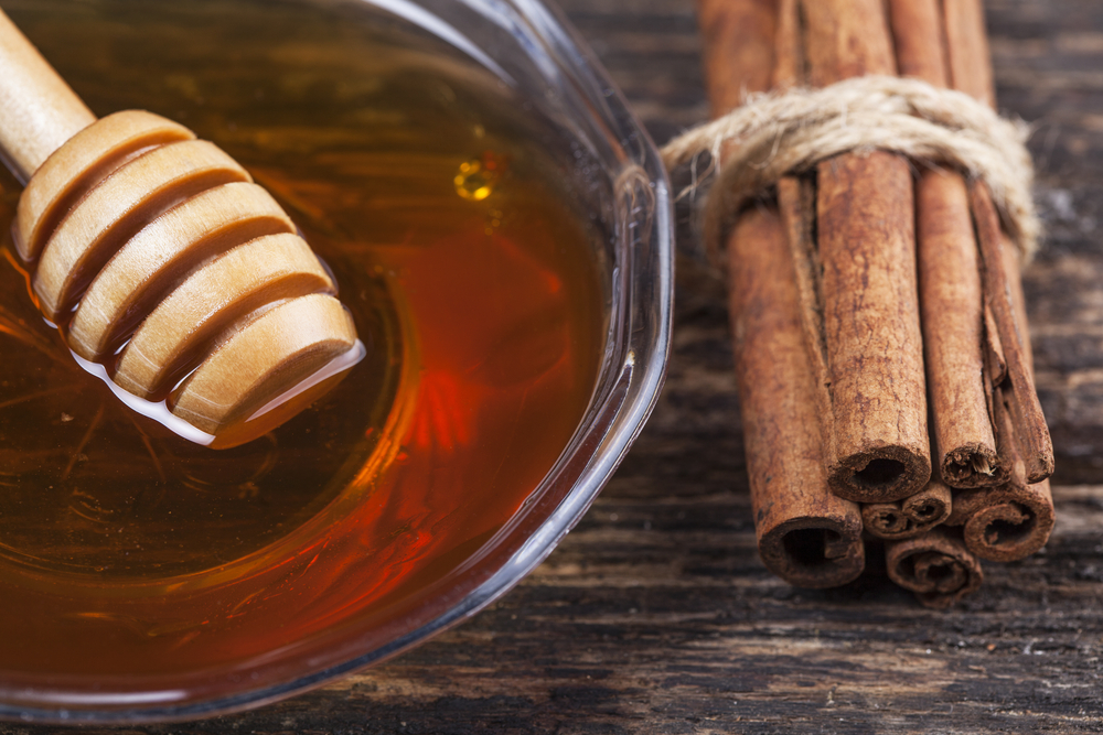 Honey with cinnamon on a wooden background
