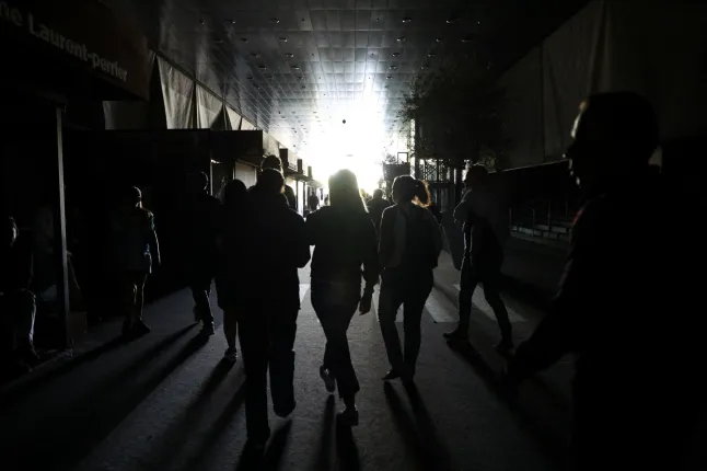 Silhouettes of people walking through a darkened building during the power outage in Madrid, Spain.