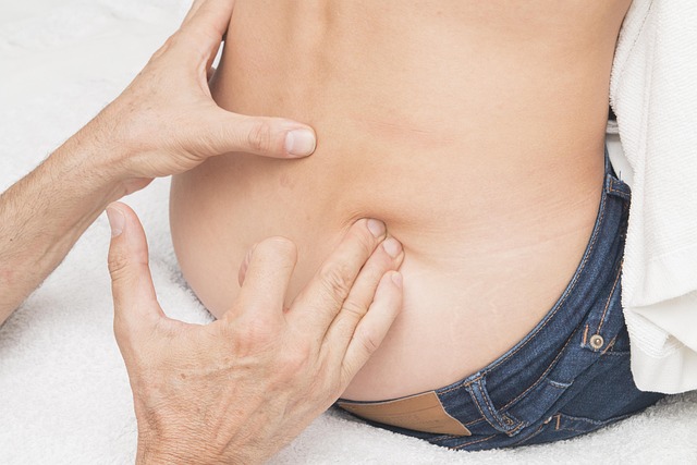 doctor touching man's lower back