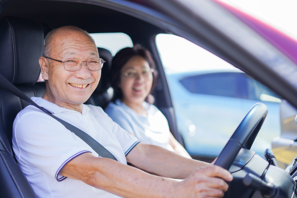 Senior couple driving a car