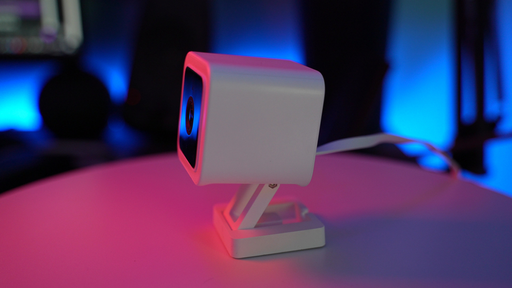 A tiny white security camera on a turn table in a studio