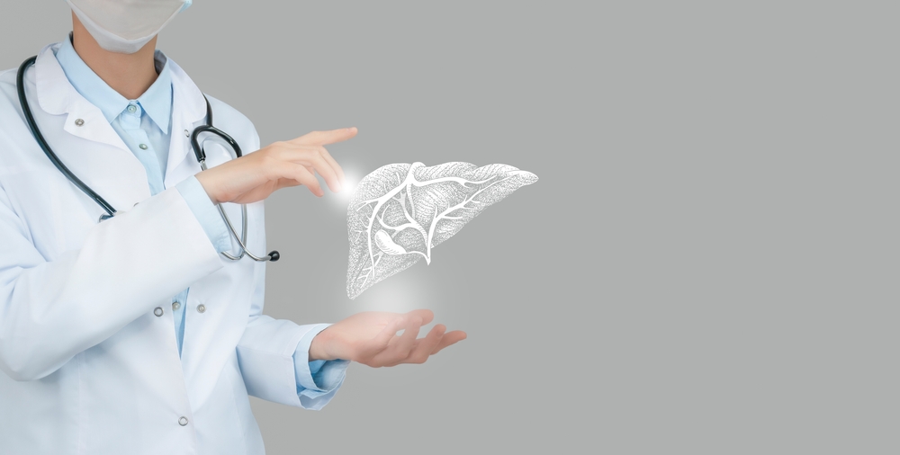 Female doctor holding virtual Liver in hand. Handrawn human organ, copy space on right side, raw photo colors. Healthcare hospital service concept stock photo
