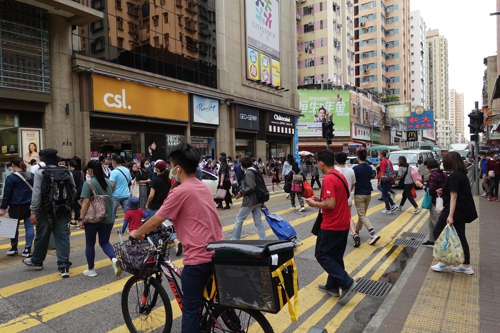 Hong Kong, China - March 27, 2022: City street view of Yuen Long and the People Wear Mask in Hong Kong.
