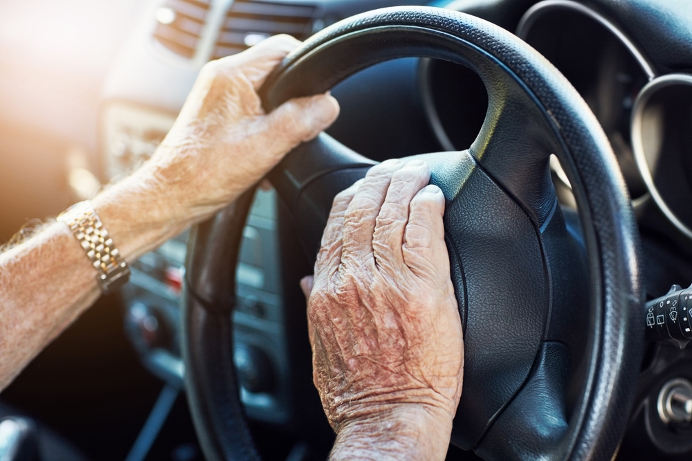 Dashboard, senior man and hand on horn in vehicle for travel, retirement and transport in street. Traffic, driving and steering wheel with person in car for adventure, holiday or road trip in city