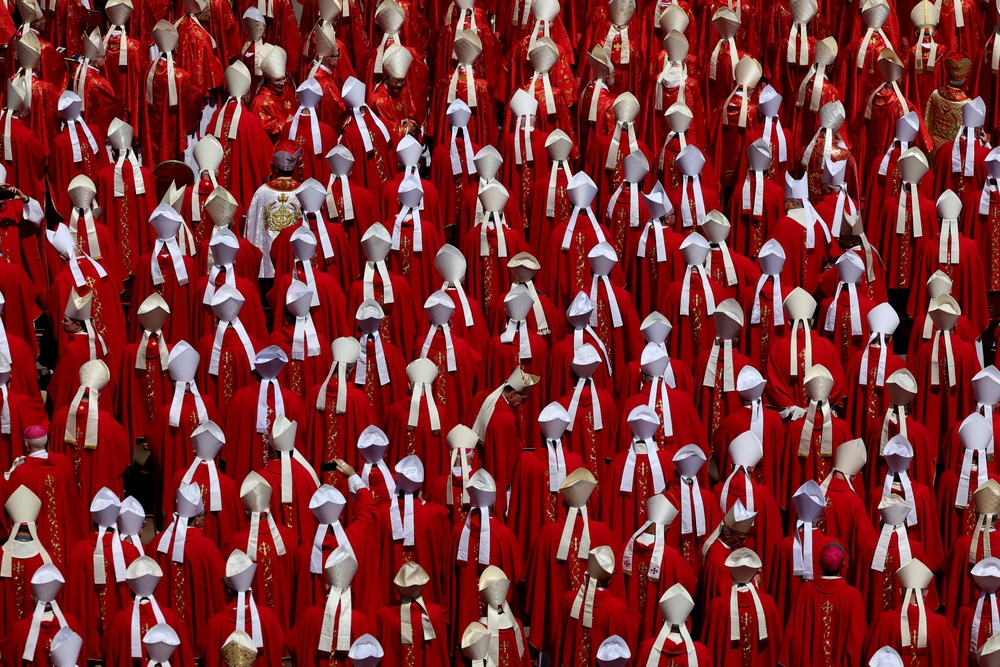 Vatican City, April 26, 2025: The purple red of the cardinals  sitting in the churchyard to participate in the funeral of Pope Francis stands out across the entire square.