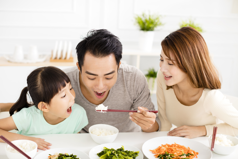 happy asian young Family enjoy their lunch
