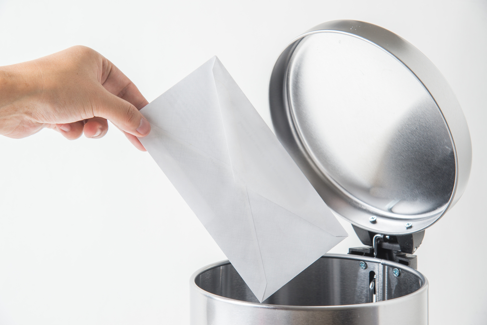 throwing away envelop, lette, mail in trashcan

