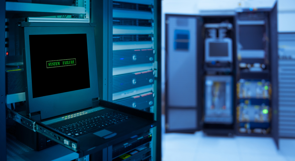 " System failure " and copyspace for text on monitor display in server room data center and blur rack server background.