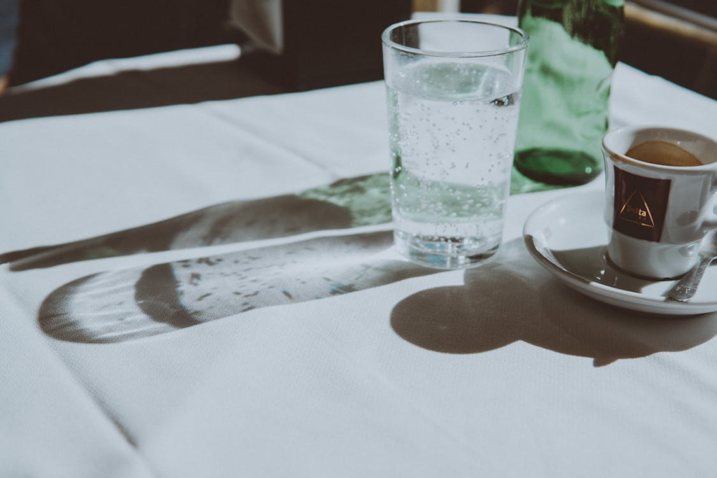 Clear Drinking Glass Beside Teacup
