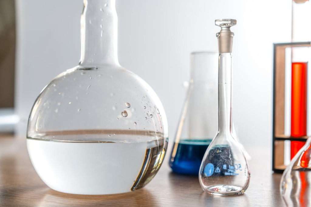 A Florence Flask with Water Beside Empty Beaker
