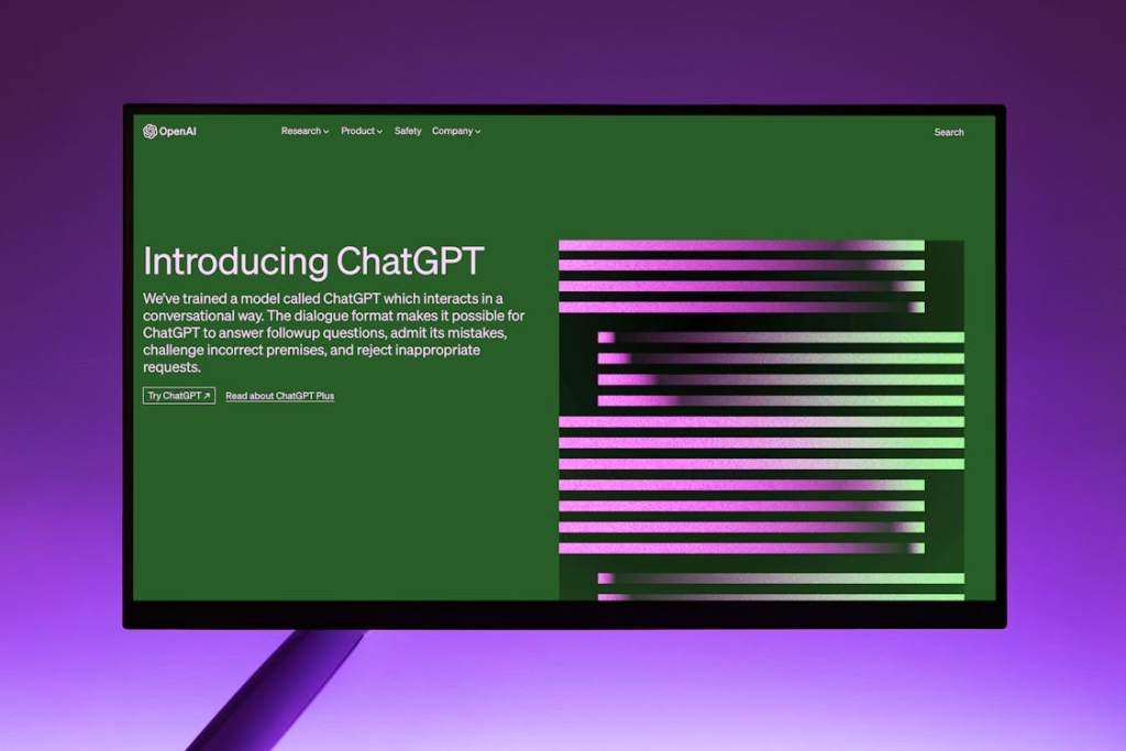 OpenAI Website with Introduction to ChatGPT on Computer Monitor

