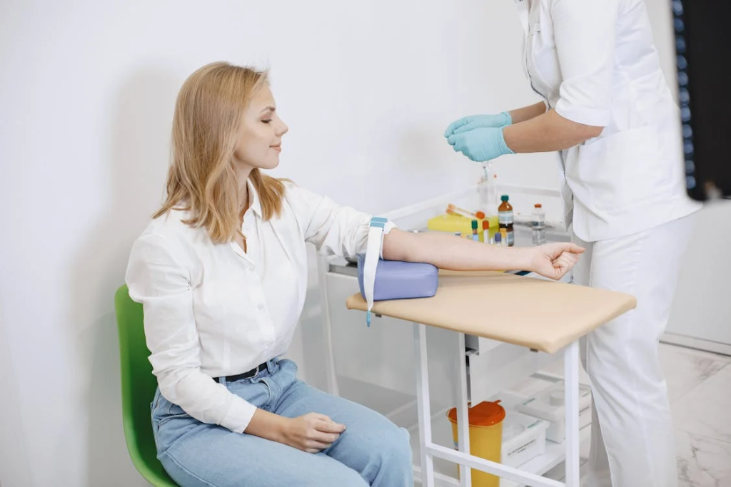 Nurse Getting a Blood Sample to a Patient

