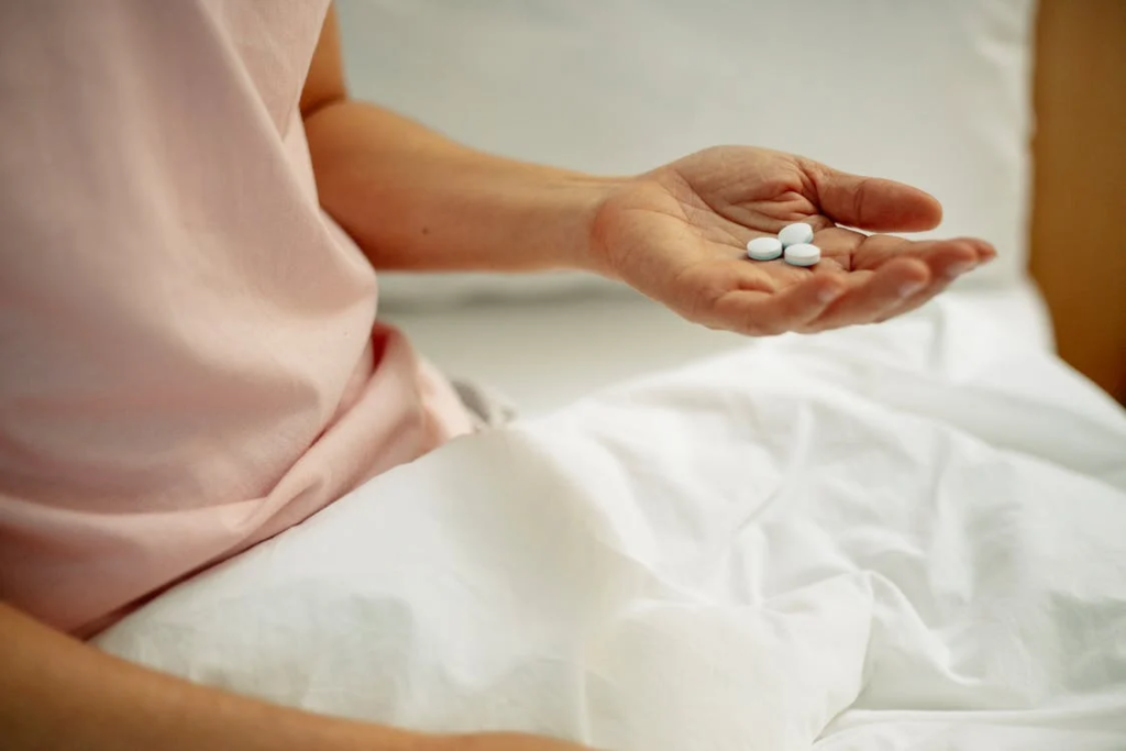 Woman preparing for taking painkiller in hand
