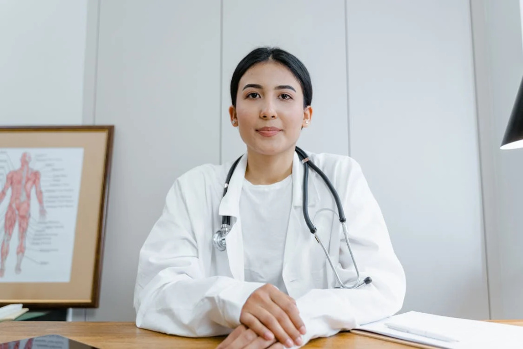 Woman in White Scrub Suit Wearing Black Stethoscope