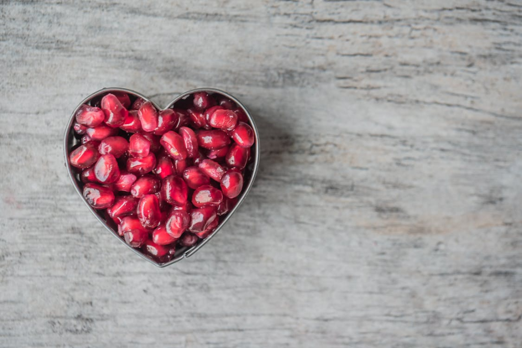 Silver Heart Bowl Filled of Red Pomegranate Seeds
