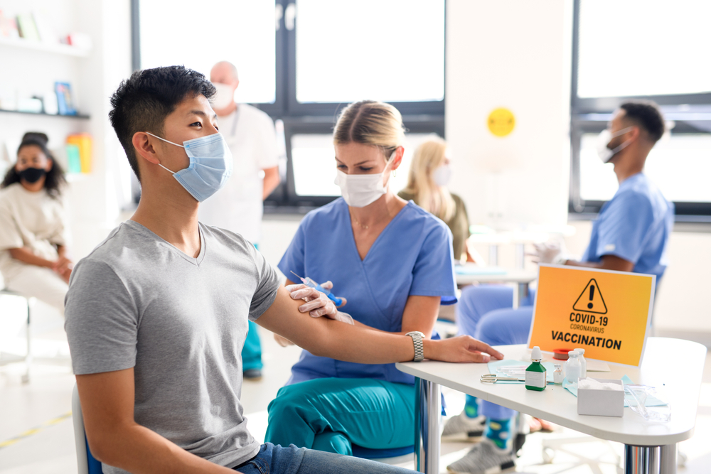 Man with face mask getting vaccinated, coronavirus, covid-19 and vaccination concept.
