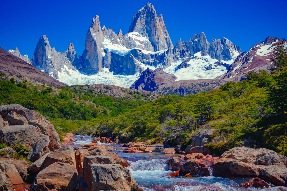 A unique and beautiful scenery: a blue river in El Chaltén, Patagonia, and Mount Fitz Roy in the background. Located at the Southern Patagonic Andes between Chile and Argentina. 