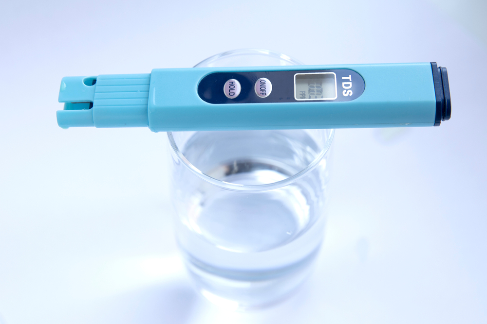 TDS measurement of water. Electronic pH meter in a glass of water.
