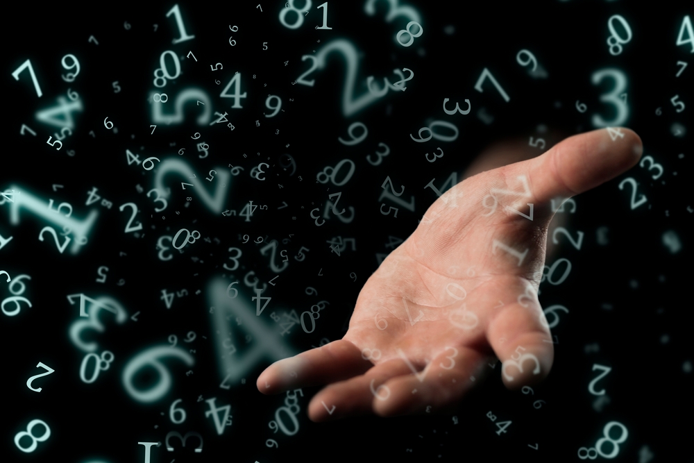 numerology, a hand outstretched out of the dark with an open palm surrounded by numbers

