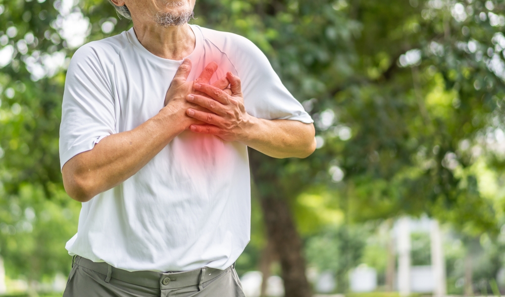 Senior asian adult elderly man with chest pain suffering from heart attack, health and medical, heart health, heart attack, world heart day, cardiovascular disease.insurance and hospital concept
