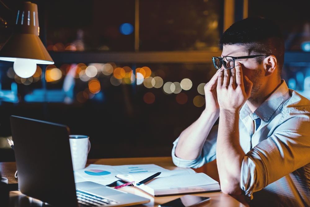 Eye Fatigue. Businessman Massaging Sore Eyes Under Glasses Having Eyestrain Sitting At Laptop In Office. Low Light