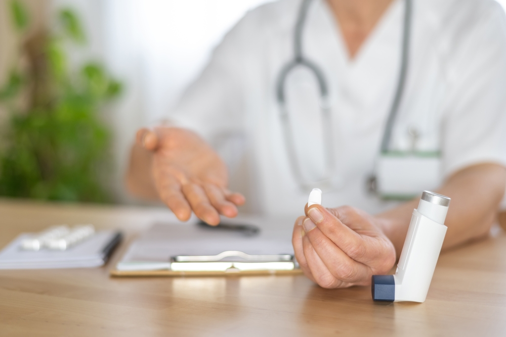 Allergist doctor is showing an inhaler and a pill, explaining treatment options for asthma or allergy during a consultation, providing healthcare and disease management