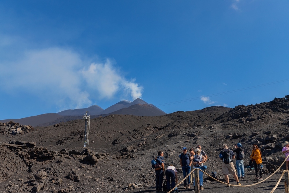 Mount Etna, Catania, Sicily, Italy - August 13, 2024: People walking on crater of active volcano in Mount Etna, Sicily, Italy
