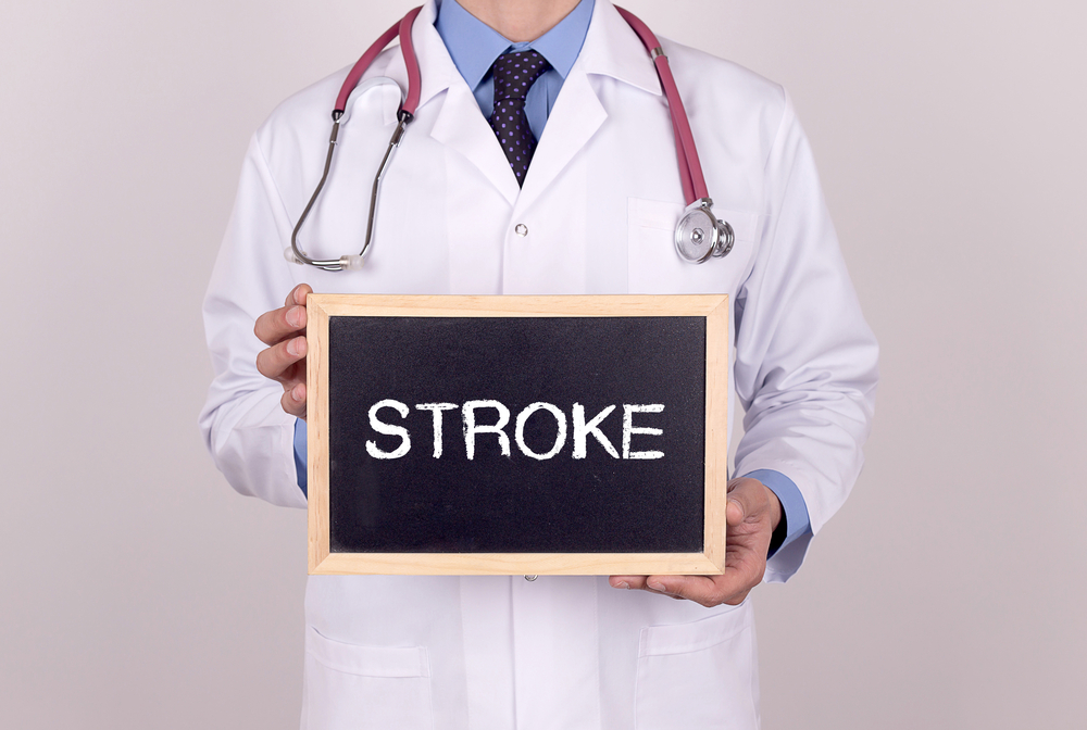 Doctor holding mini blackboard with STROKE message