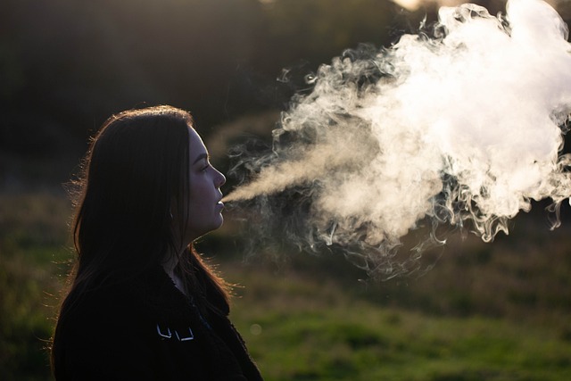 woman blowing out vape cloud