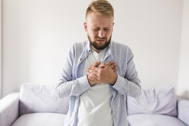 man holding chest in pain