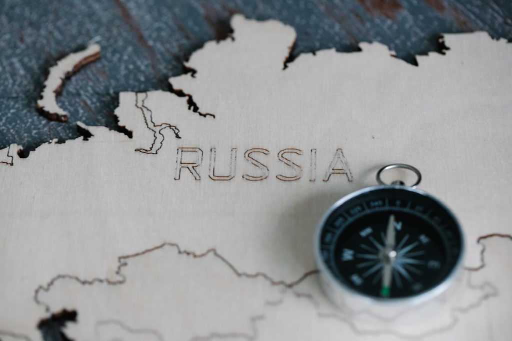 Compass on Wooden Map of Russia
