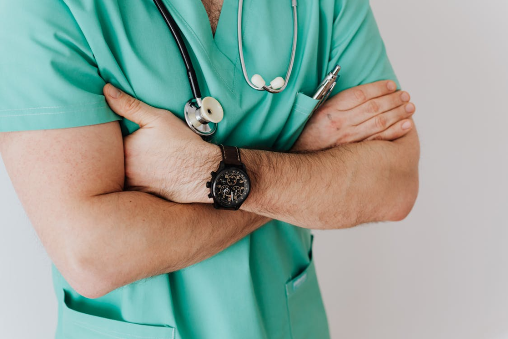Unrecognizable crop man in wristwatch with stethoscope
