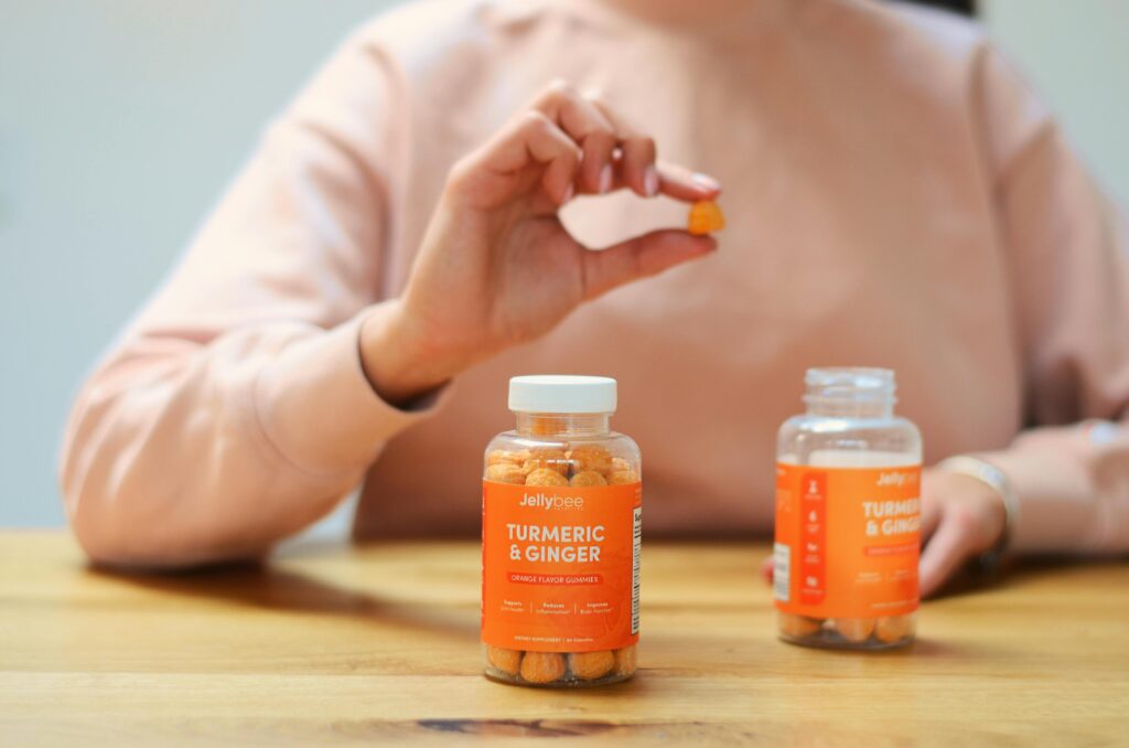 A Bottle of Candies on the Wooden Surface