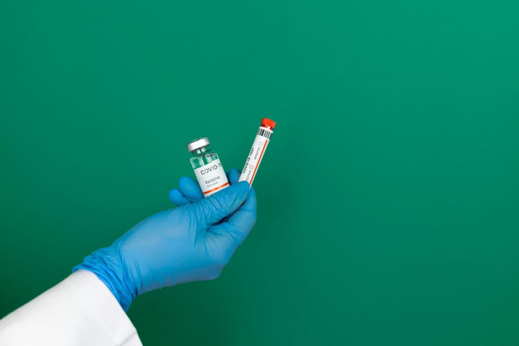 A Person Holding White Labeled Vaccine Bottle
