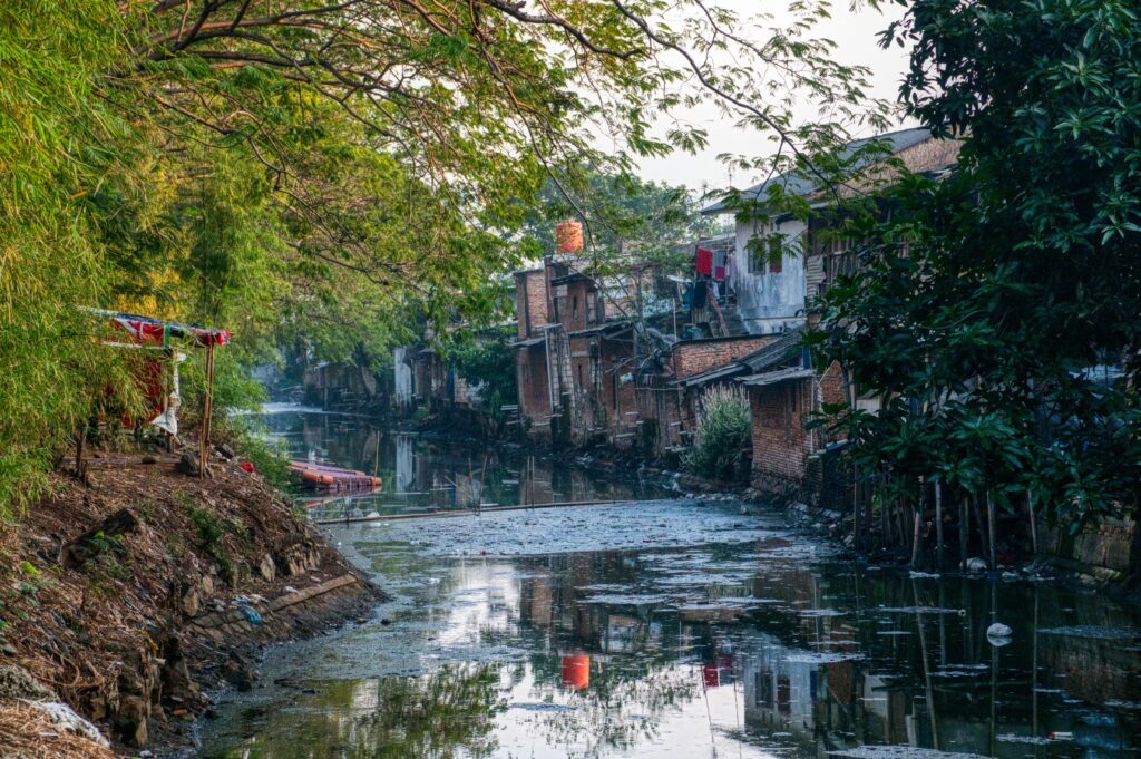 Photo of a Polluted River Near Houses