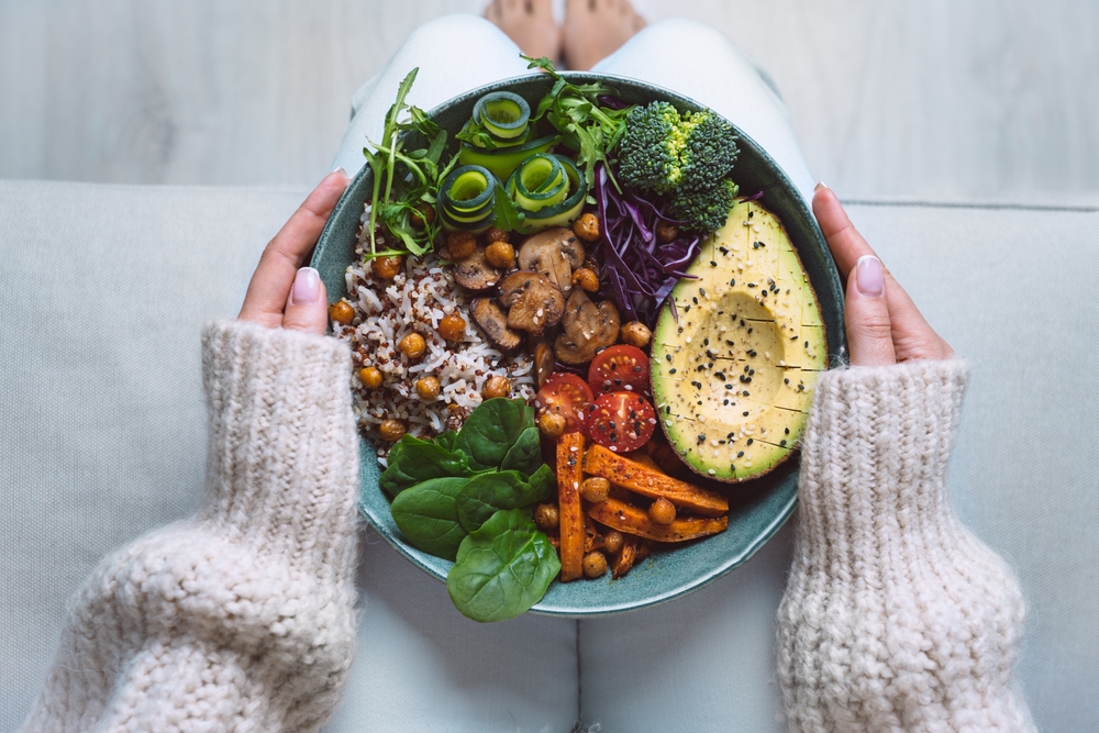 Healthy eating. Plate with vegan or vegetarian food in woman hands. Healthy plant based diet. Healthy dinner. Buddha bowl with fresh vegetables
