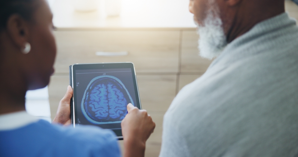 Healthcare, tablet screen or brain scan by doctor with old man for medical, analysis or diagnosis. Neuro, digital radiography or neurologist and patient for Alzheimer, dementia or memory loss surgery
