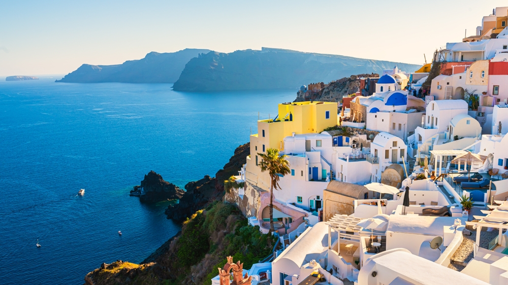White architecture in Santorini island, Greece. Beautiful view of Oia town at sunset. Travel and vacation concept