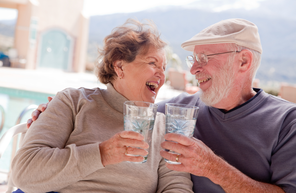 Happy Senior Adult Couple Enjoying Drinks Together.
