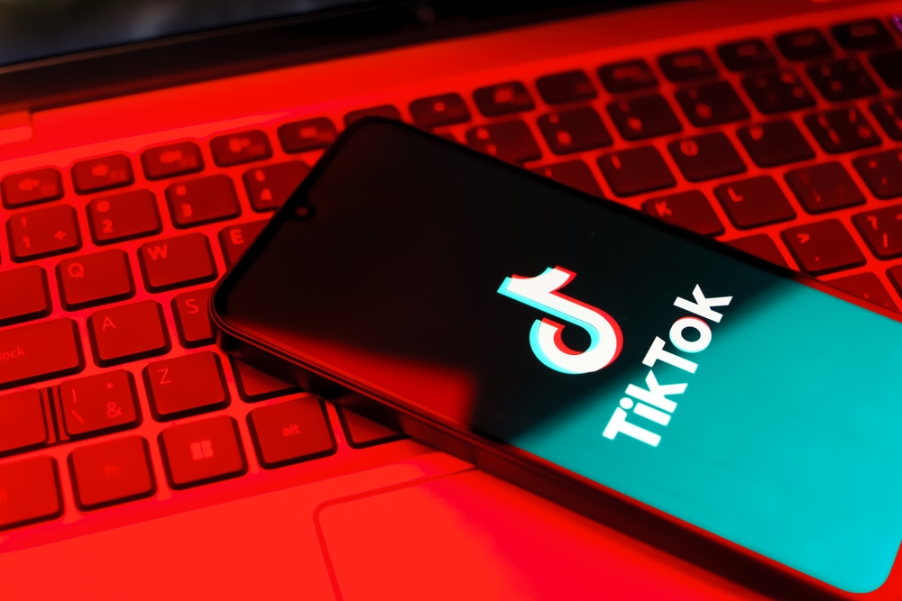 Prague, Czechia - 7 20 2024: Smartphone on surface showing TikTok logo.